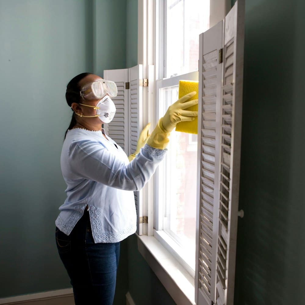 An Epic Cleaners team member cleaning a kitchen surface